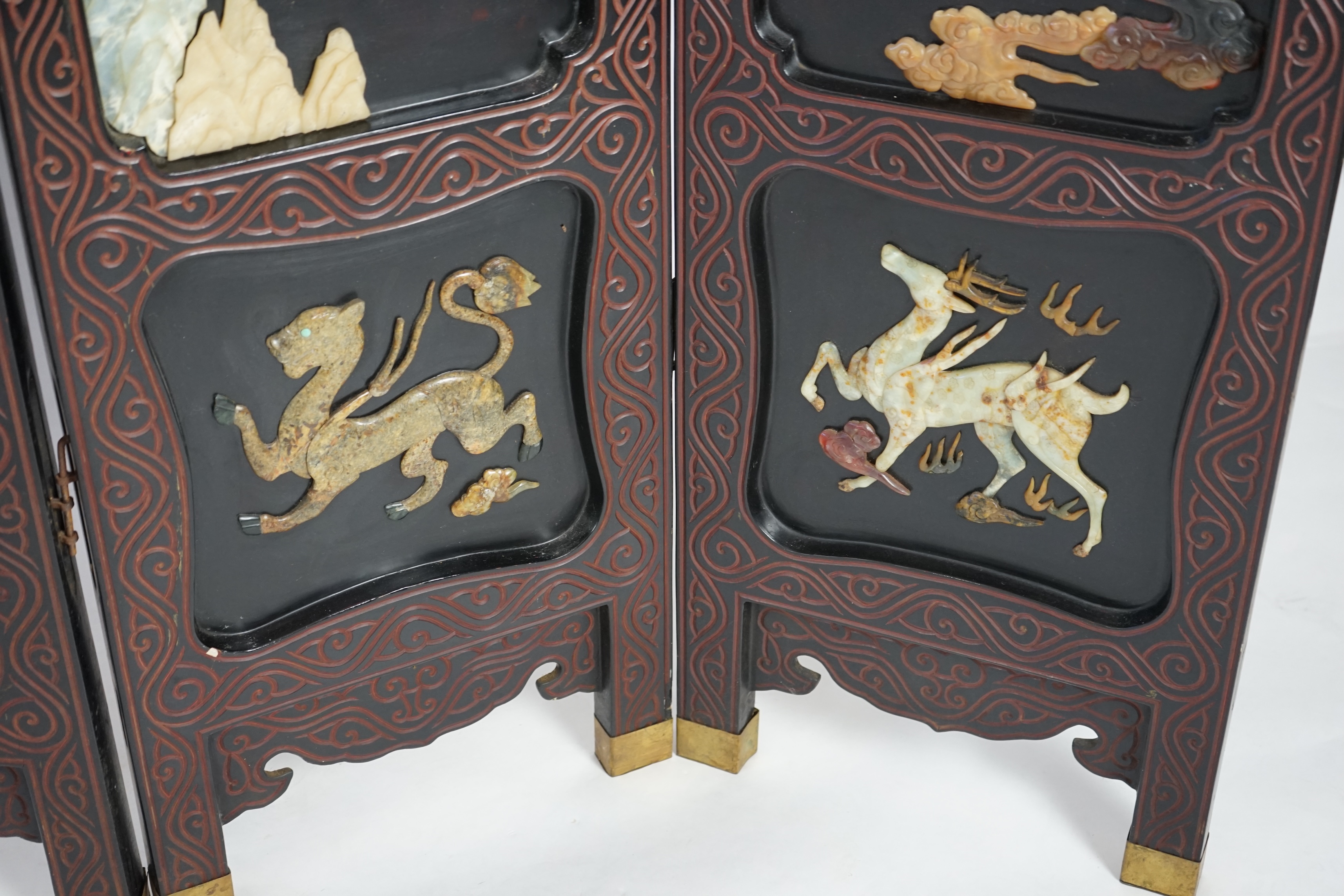A Chinese tixi lacquer and carved soapstone overlaid six panel screen, mid 20th century